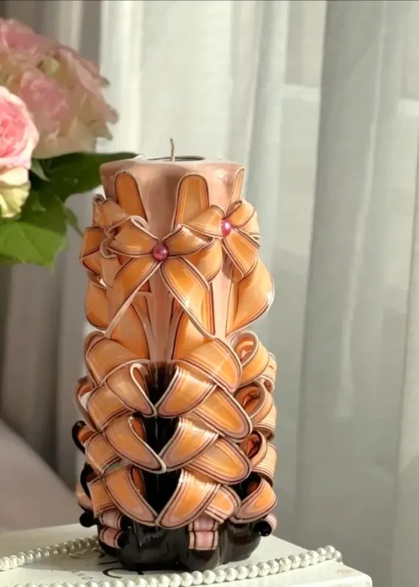 Large hand-carved rose candle with bold black, orange, and white layers, packaged in a luxurious gift box with elegant ribbon.