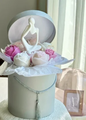 Delicate wax flowers and a thinking man candle in a pastel gift box – ideal thoughtful gift for students