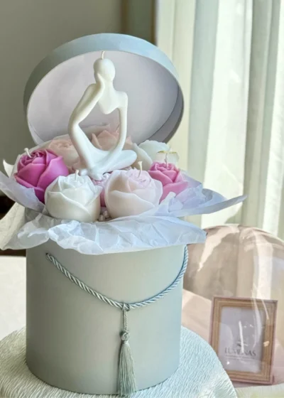 Delicate wax flowers and a thinking man candle in a pastel gift box – ideal thoughtful gift for students