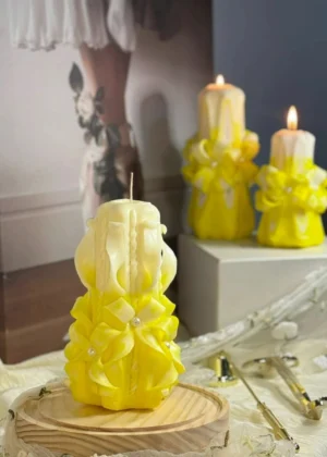 Hand-carved yellow and white soy wax candle with elegant folded layers in a luxurious gift box with satin ribbon, scent-free decorative candle.